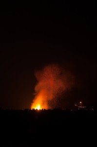 Sparks and flames climb to the sky as the effigy collapses at Alchemy 2012.